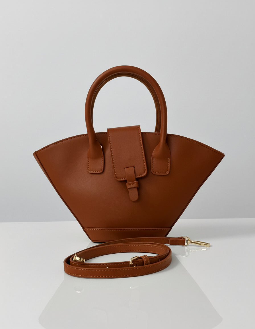 Brown handbag with a strap on a white background