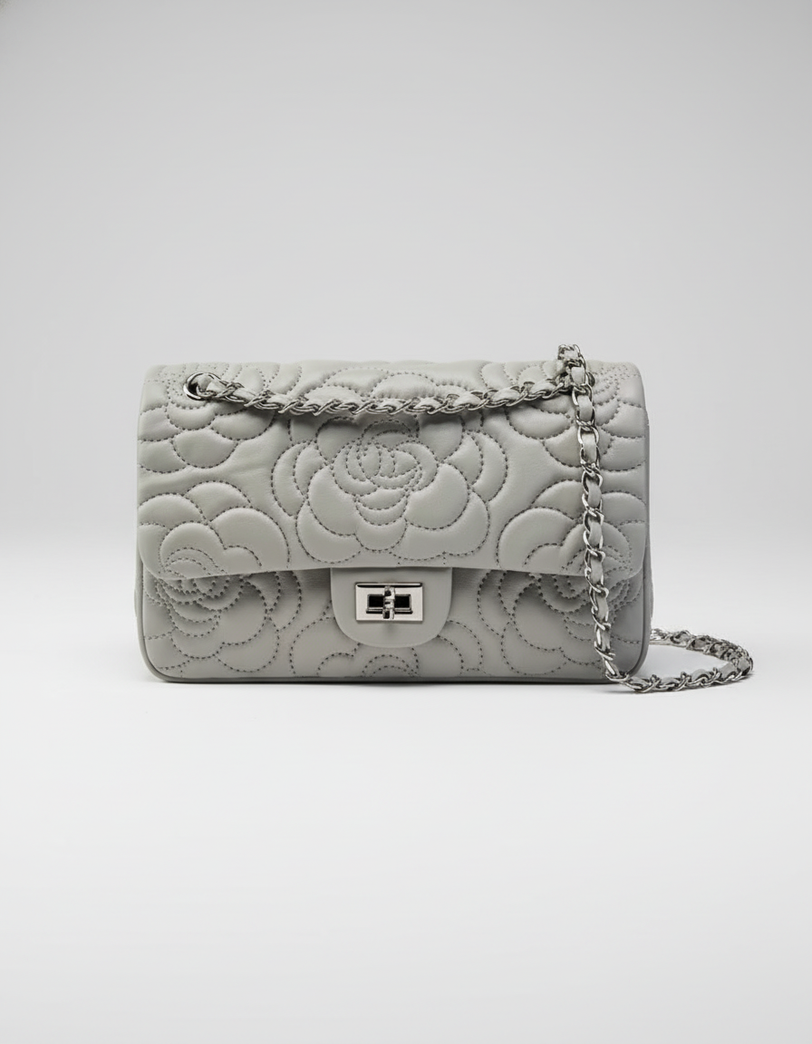 Gray quilted handbag with chain strap on a white background